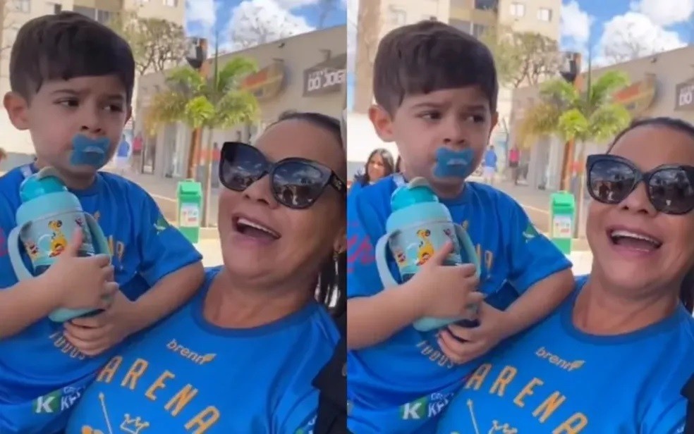 O menino estava no colo da avó durante o encontro