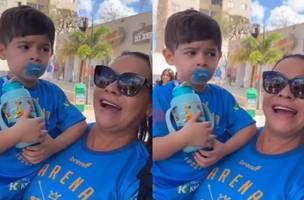 O menino estava no colo da avó durante o encontro (Foto: Reprodução)