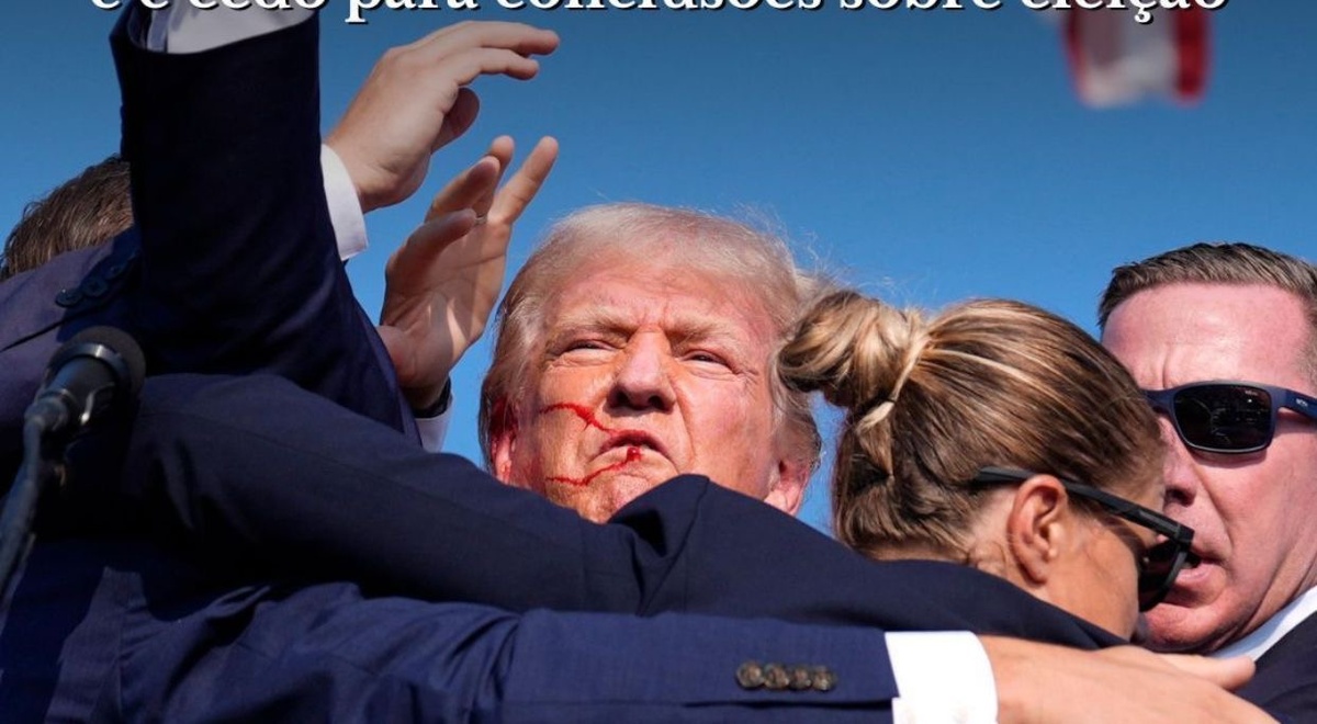 Trump com o rosto sangrando sendo retirado do palanque