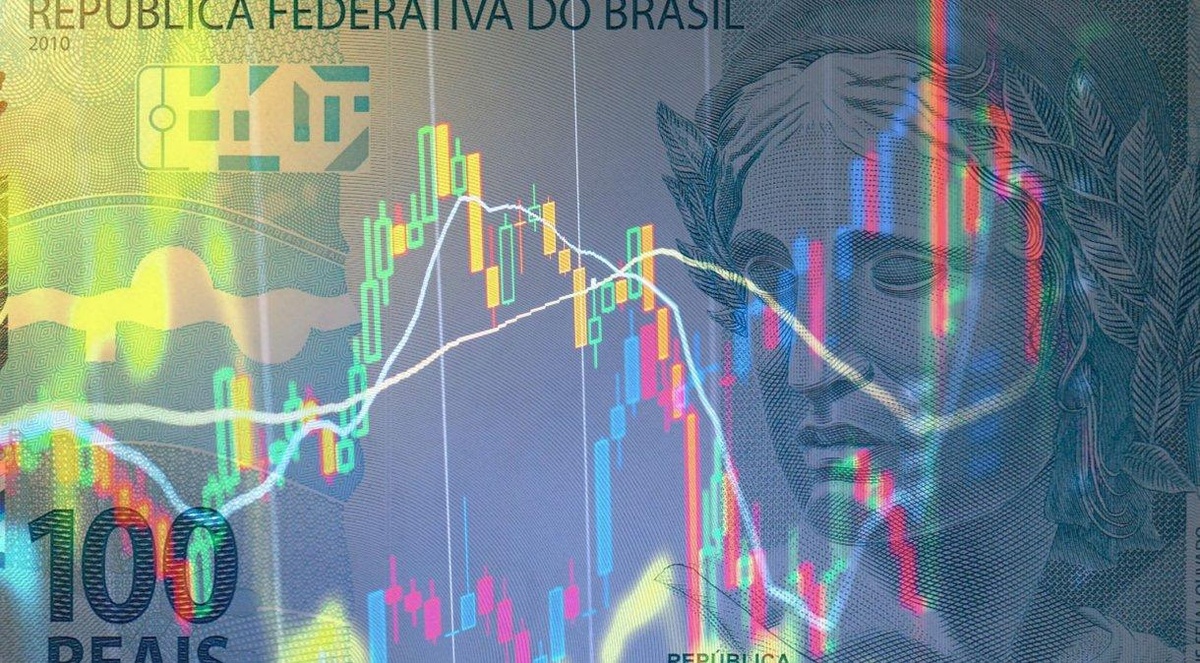 Cédula de real ao fundo de gráficos / economia brasileira• Anton Petrus / Getty Images