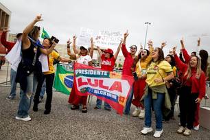 Apoiadores de Lula da Silva gritam slogans do lado de fora de uma seção eleitoral onde brasileiros residentes em Portugal votam nas eleições presidenciais, em Lisboa, em 25 de outubro de 2026.